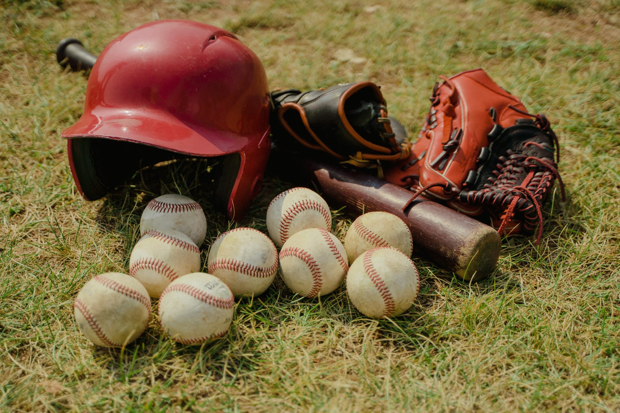 Photo by Tima Miroshnichenko: https://www.pexels.com/photo/red-baseball-helmet-on-green-grass-field-5184709/